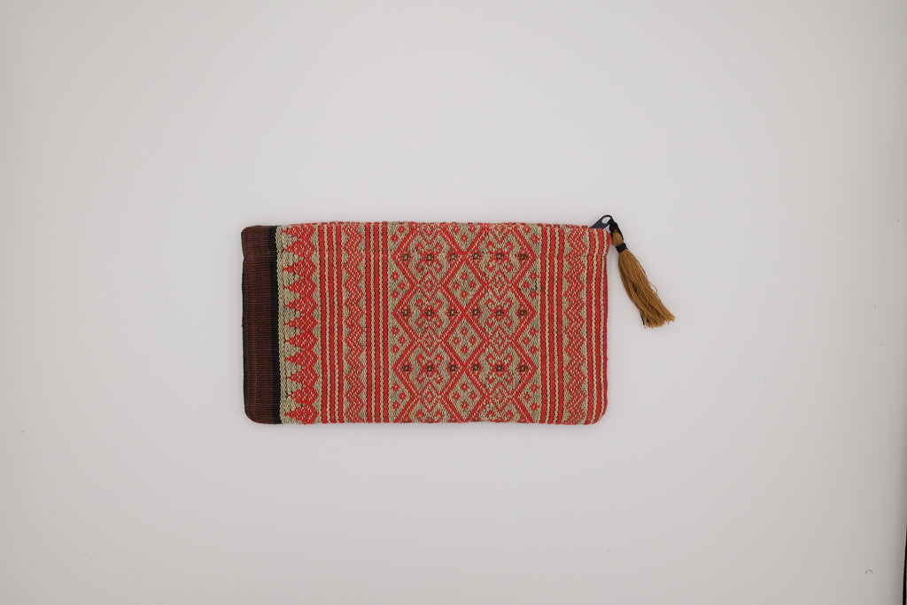 Woven pouch with red and brown pattern on a white background