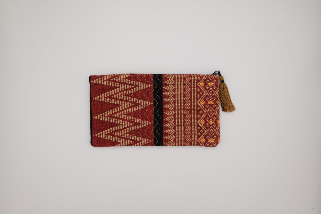 Patterned pouch with a tassel on a light gray background