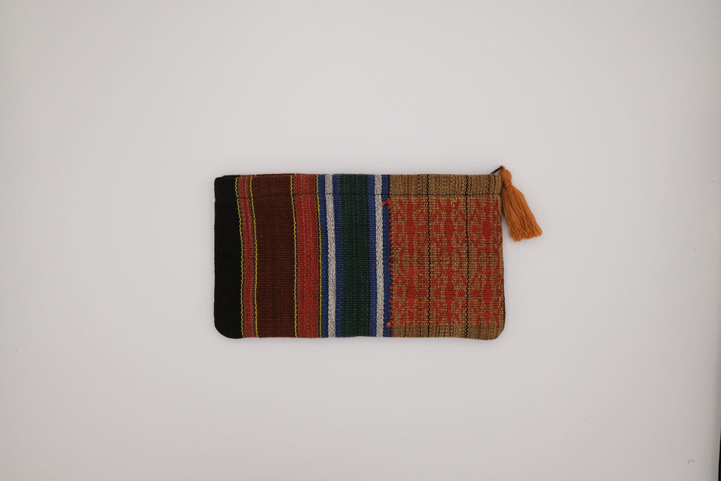 Colorful woven pouch with a tassel on a white background