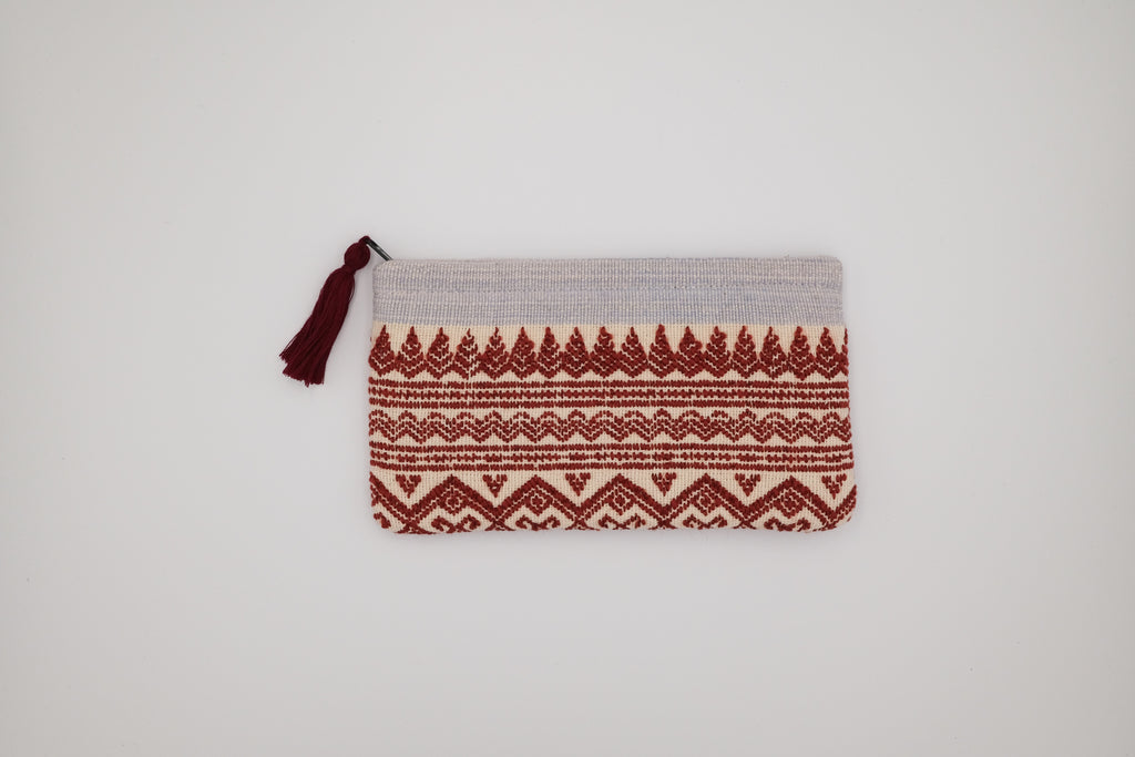 Woven pouch with red and beige pattern on a light gray background
